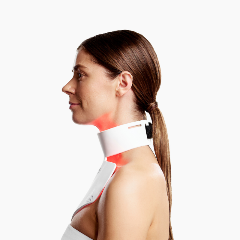 Woman using CurrentBody LED Neck & Décolletage Mask Series 2 on her neck and chest side view